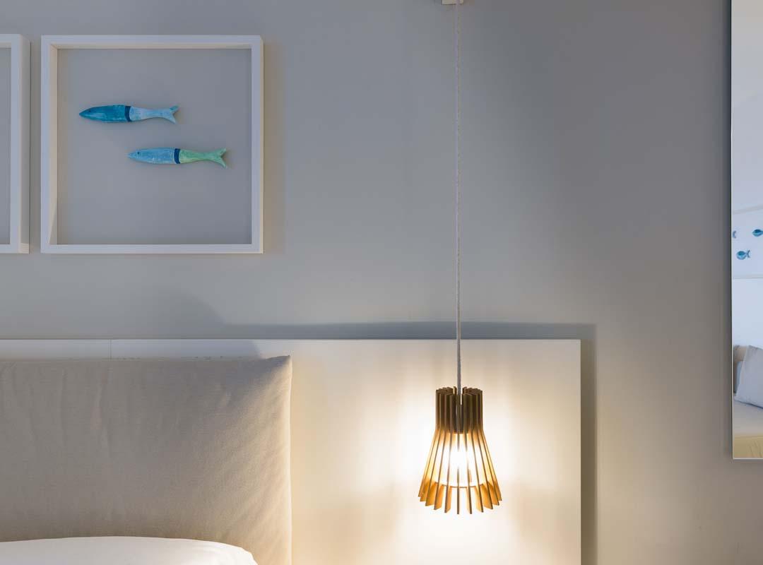 Elegant, minimalist bathroom with white towels and plants, evokes calm and cleanliness.